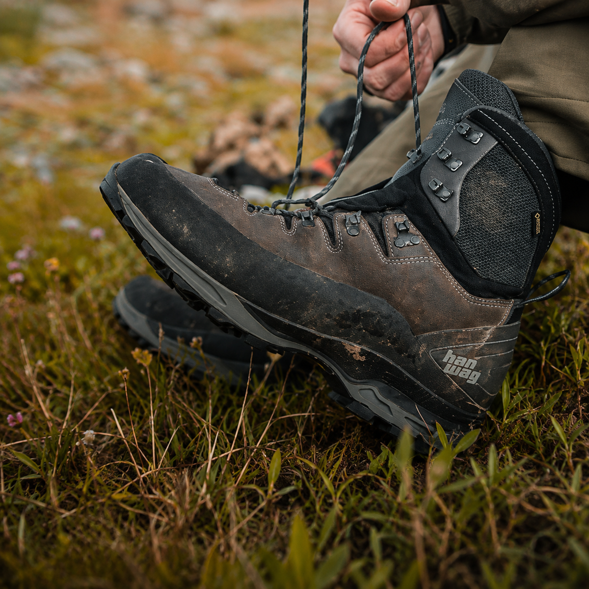 Close-up of a hiking boot being laced outdoors