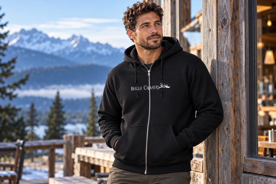 Illustrative mountain cafe styling scene with a black Bugle Chaser full-zip hoodie